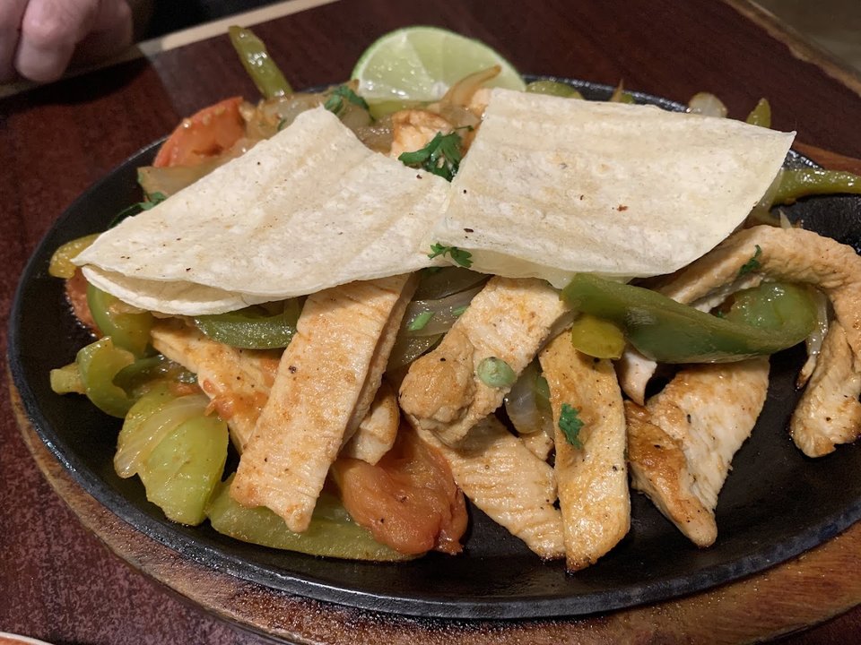 A shared meal with tacos, burrito, and sides.
