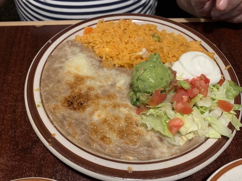 Printed menu with burritos, soups, and seafood plates.
